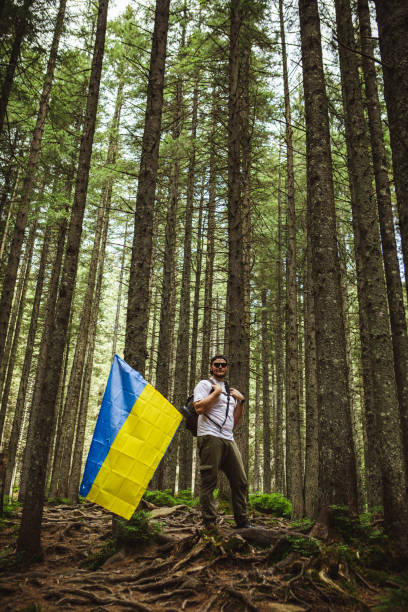 istock A man in the forest with a ukrainian flag 1533635245