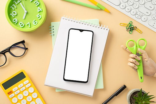 Explore the possibilities of remote learning with this creative top-down snapshot displaying smartphone on a notebook with keypad, clock, glasses and calculator beige isolated background