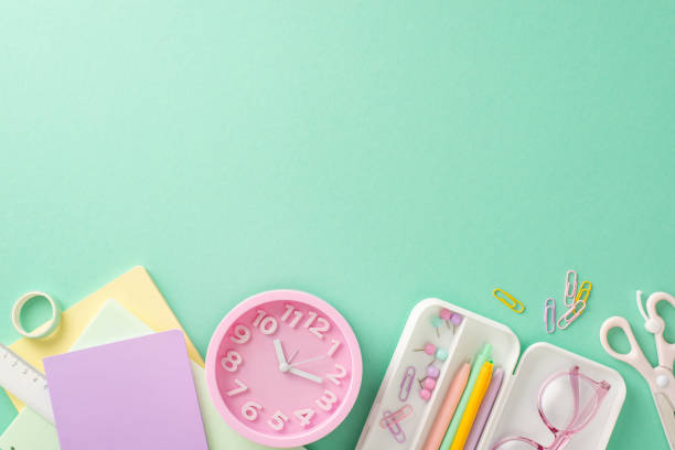 istock Get ready for the new academic season with this top-view shot featuring vibrant clock and stationary essentials on a pastel blue backdrop. Customize the copy-space with text or advertising 1533655761
