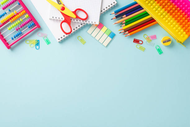 istock Delightful educational essentials arranged in a top view composition: a vivid assortment of colorful materials on a serene pastel blue background, providing copyspace for text or advertising 1533659292