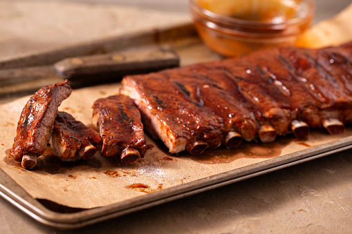 St. Louis style pork spareribs bbq plate with sauce.