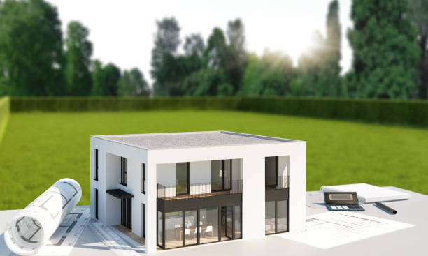 istock Model of a modern cubic house with planning drawings on a table 1533673984