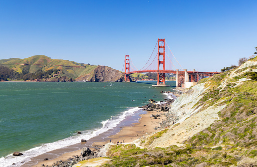 Aerial view of Golden Gate Bridge over bay and islands at sunset