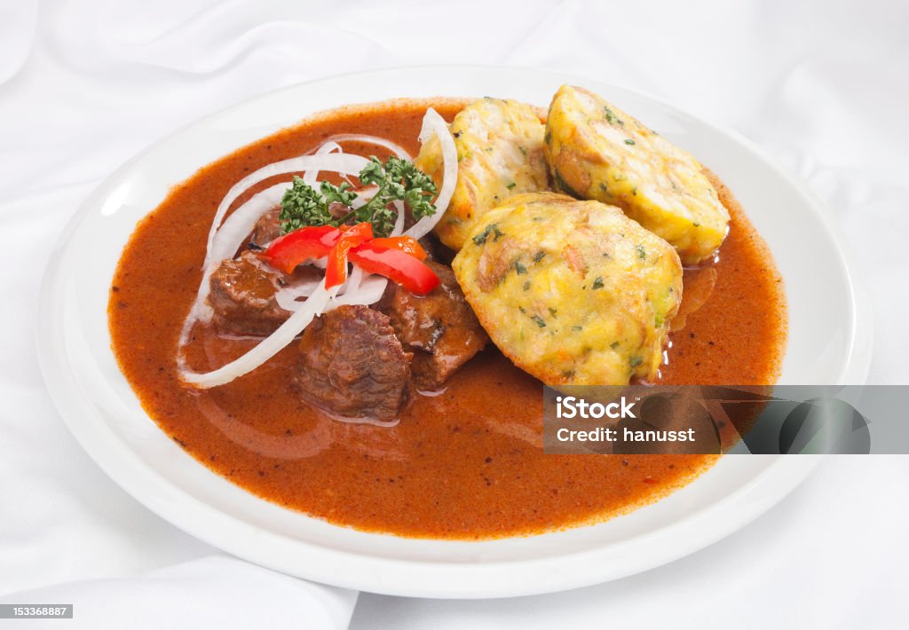 Hungarian goulash Hungarian goulash w dumplings and vegetable garnish Dumpling Stock Photo