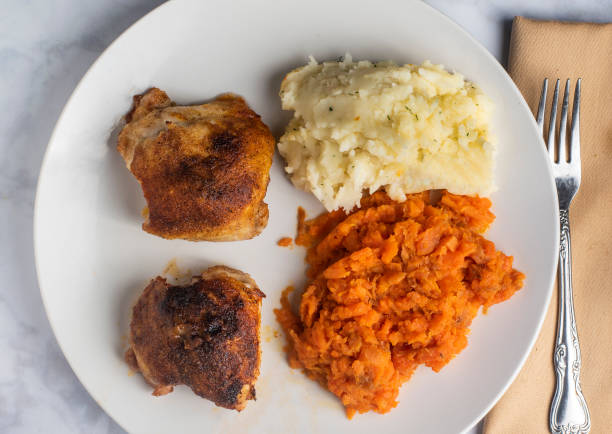 istock chicken thighs  with mashed carrots and potatoes 1533704087