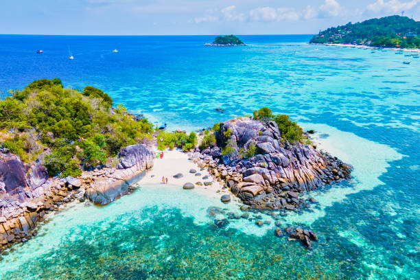 couple with a kayak on a small Island in front of the Island Ko Lipe Thailand couple with a kayak on a small Island in front of the Island of Ko Lipe Thailand, Kla Island satun province stock pictures, royalty-free photos & images