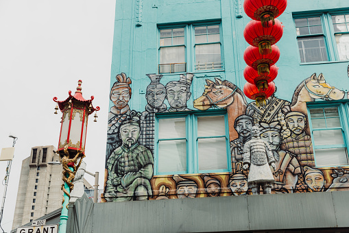 March 19, 2023: view of turquoise coloured authentic building with graffiti and traditional Chinese decoration in Chinatown, the United States