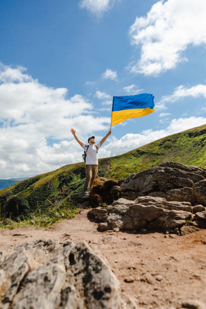 istock A man on the mountains with a ukrainian flag 1533726814