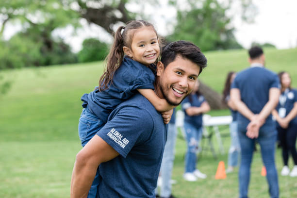 istock Portrait young dad carrying elementary age daughter piggyback 1533752669