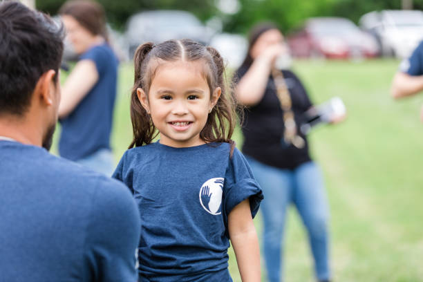 istock Elementary age girl standing by father looks at camera 1533752692