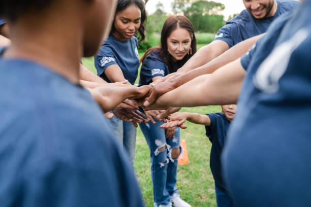 istock Low angle view of diverse volunteers' hands together 1533752724