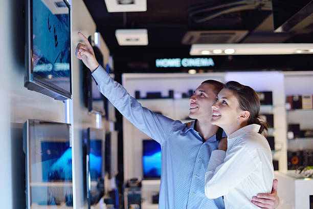 istock Young couple in consumer electronics store buy tv 153376588