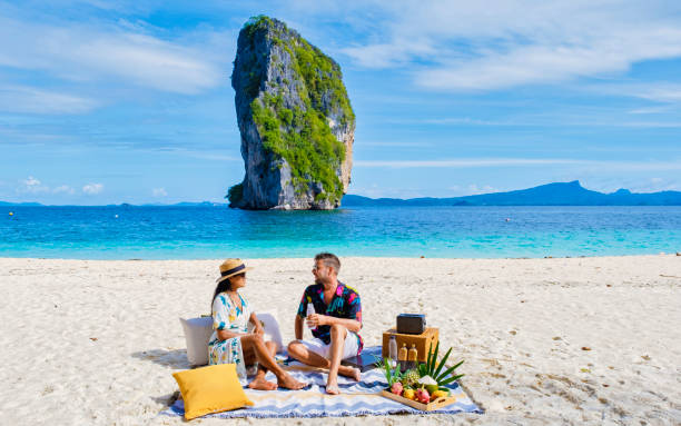 koh poda beach krabi thailand, ein paar männer und frauen am strand picknick mit obst und getränken - ao nang stock-fotos und bilder