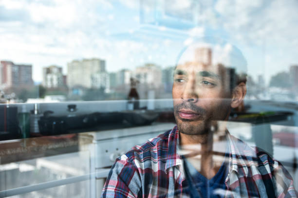 istock Mature man contemplating while look through window at home 1533789276