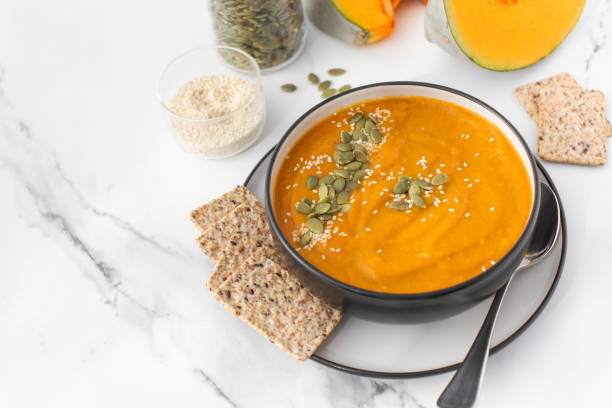istock A bowl of pumpkin soup with mashed potatoes and seeds. Autumn menu. Copy space 1533789380