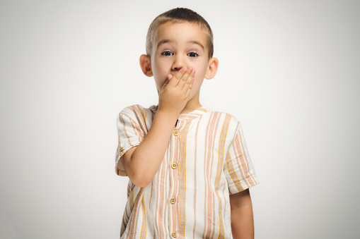 Studio shot portrait of a child boy on grey background