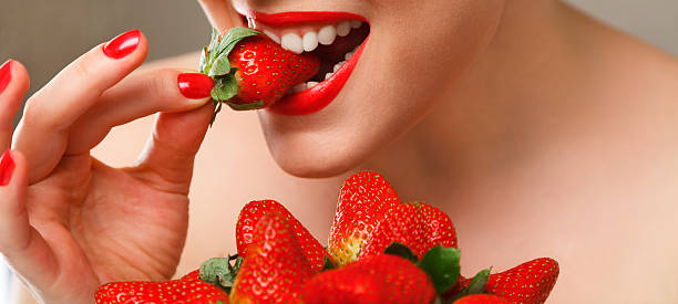 istock Woman eating strawberry 153380106