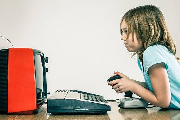 little girl playing vintage video games with retro joy stick - gamer video game 1980s style television stok fotoğraflar ve resimler