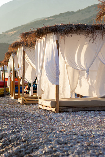 White beach canopies. Luxury beach tents at a resort. Beach holiday concept.