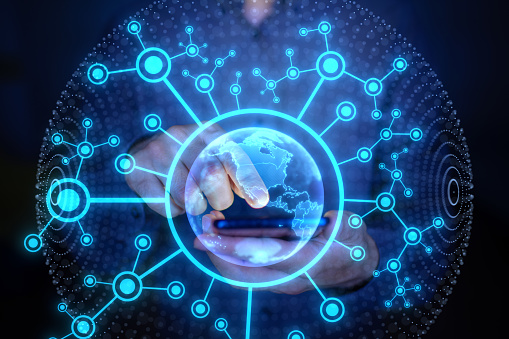 Man touching phone with holographic globe. Concept of global network connection, big data, internet, sustainable development, data exchanges, worldwide business, telecommunication and finance.
