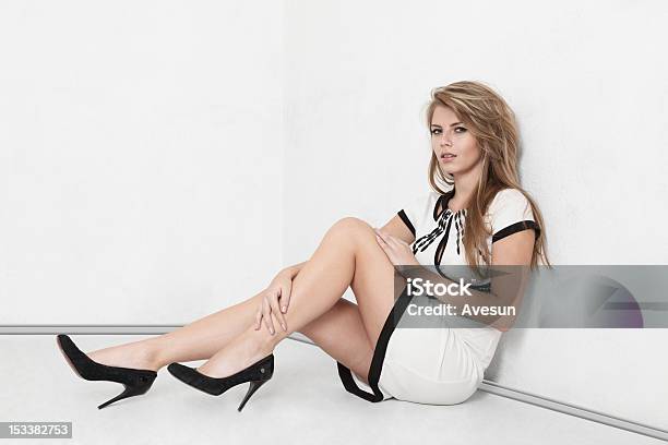 Young Woman Sitting On Floor Stock Photo - Download Image Now - Full Length, High Heels, Blond Hair