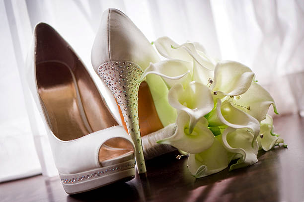 Bridal shoes and bouquet stock photo