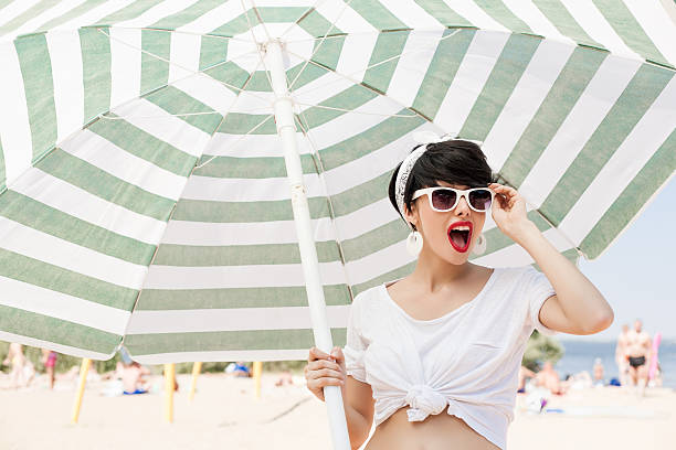 Woman with glasses on sunny beach stock photo
