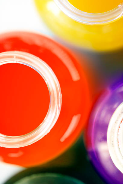 Multicolored energy drinks and juices in opened bottles