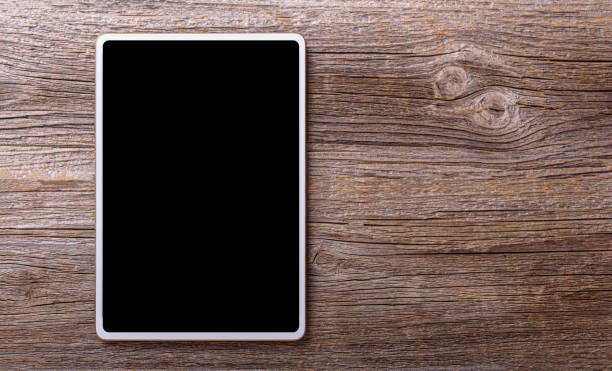 istock White tablet on a wooden background. 1533865216