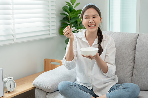 healthy food. Beautiful female girl enjoy eat yogurt, granola, fresh fruits on breakfast health in house. Happy young woman smile on morning good emotion. dieting, detox, diet, clean eat, vegetarian