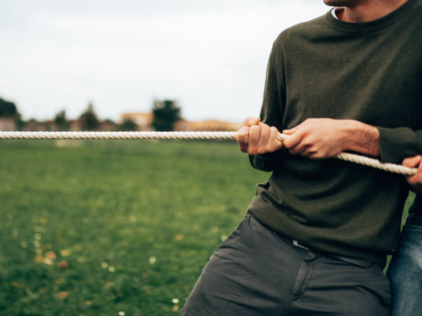 istock doing the tug of war men vs women 1533882971