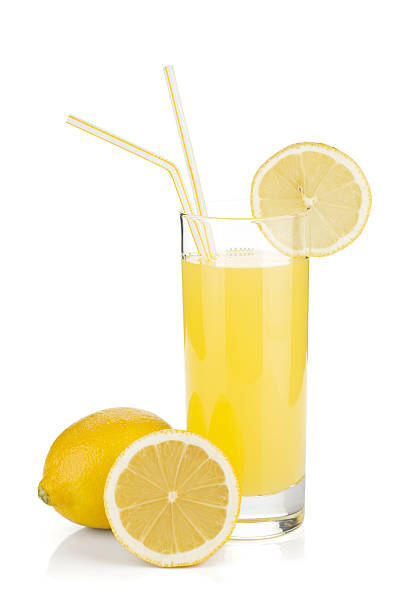 Lemon juice glass and fresh lemons