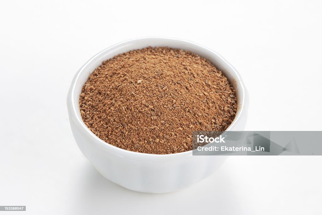 Cinnamon ground in a bowl on white background. Cinnamon ground in a white bowl on white background.  As a spice or condiment cinnamon sold in the form of sticks or a hammer. Used as a spice in cuisines all over the world. Bowl Stock Photo