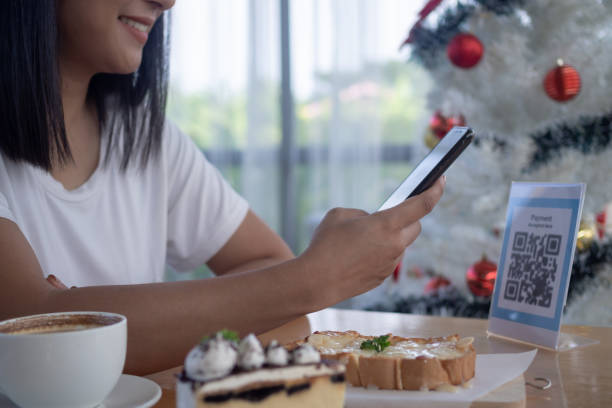 istock Woman use smartphone to scan QR code for order menu in cafe restaurant with a digital delivery. Choose menu and order accumulate discount. E wallet, technology, pay online, credit card, bank app. 1533885753