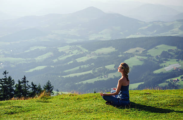 istock Woman meditating on the grass outside 153388635