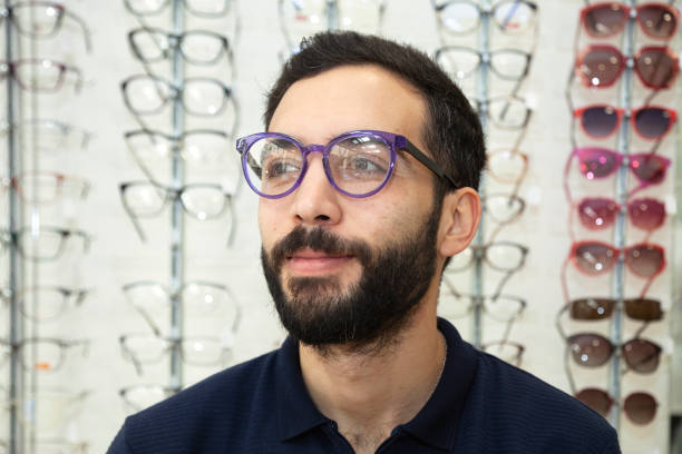 istock Men trying glasses in an optician 1533889542