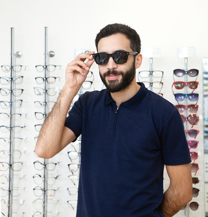 Men trying glasses in an optician