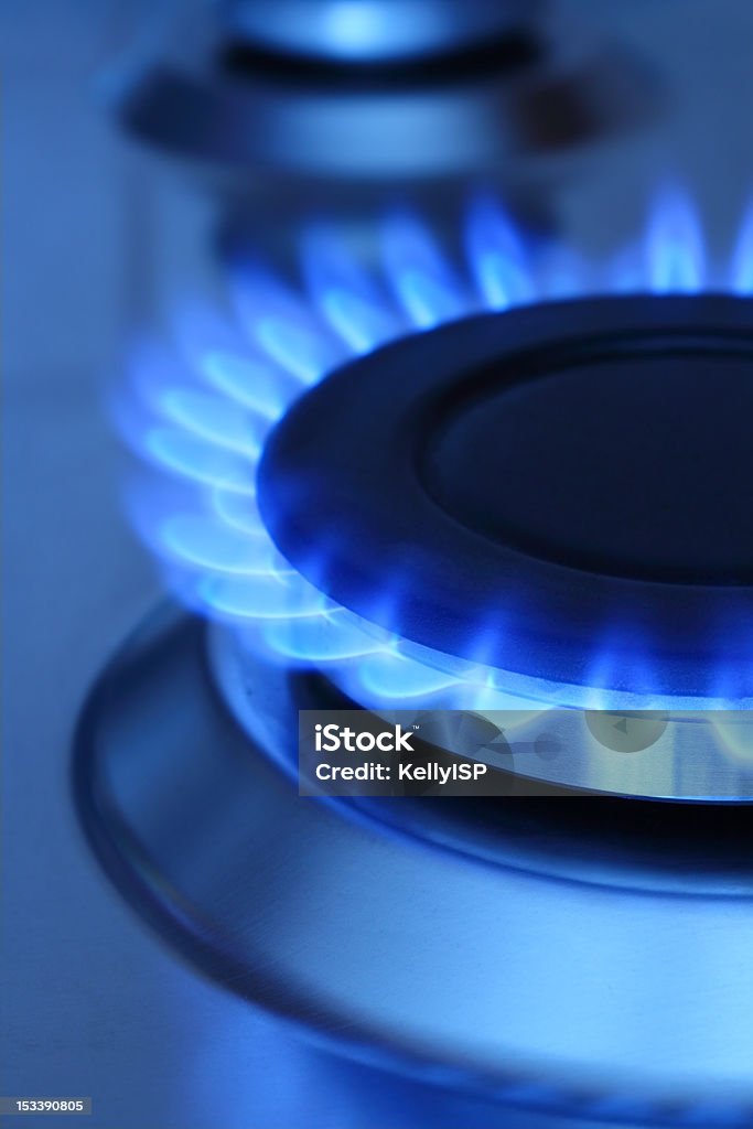 Blue flames coming from natural gas Blue flames of natural gas burning from a gas stove. Vertical composition. Blue Stock Photo
