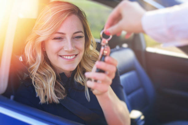 istock A woman's hand passes the key to the car. 1533915823