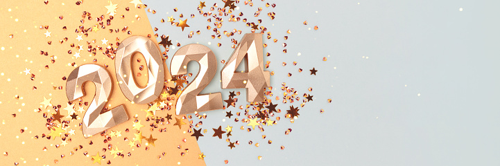 Banner with 2024 numbers and shiny stars confetti on a golden and blue background. New Year concept.