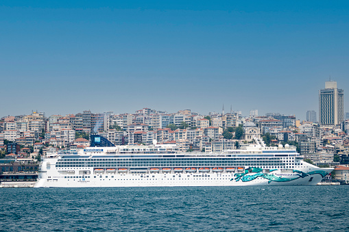 Istanbul Turkey - July 11, 2023: Cruise ships are luxury ships that travel to multiple destinations and contain all kinds of amenities. The cruise ship in this photo has delivered its passengers to Istanbul and is waiting to travel to another destination.