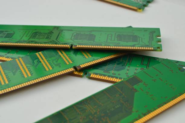 Close-up of a PC RAM memory card, on a light background, illustrating the power and speed of the technological components. Close-up of a PC RAM memory card, on a light background, illustrating the power and speed of the technological components. motherboard ram slots stock pictures, royalty-free photos & images