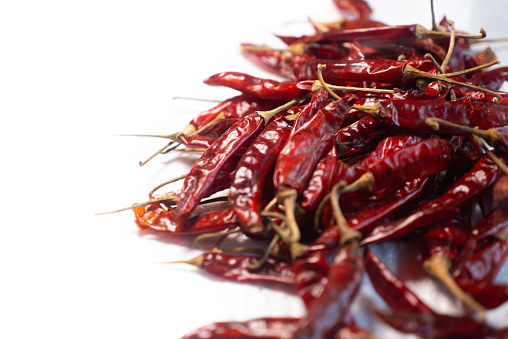 Bright Red dried red chillies are display on white background