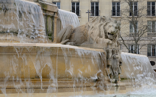 Detail of lyon statue at fountain of Saint Sulpice in Saint Germain quarter in Paris, France.