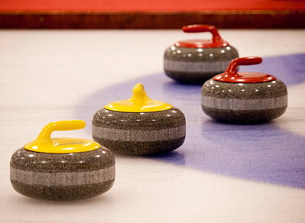 istock Four multicolored curling stones at edge of house 153398368