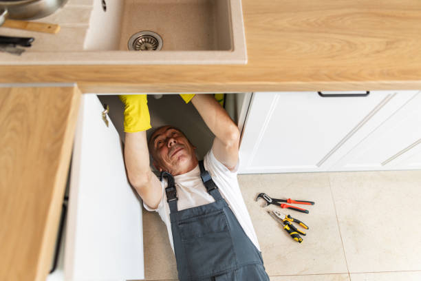 istock The plumber fixing the sink in the kitchen 1533987583
