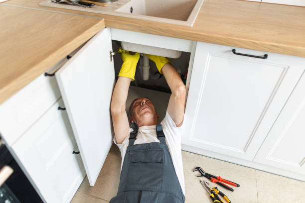 istock The plumber fixing the sink in the kitchen 1533988706