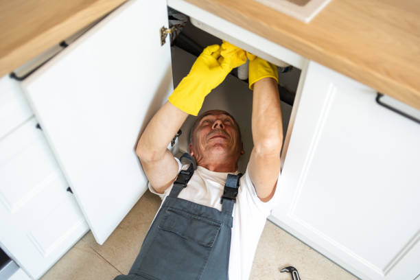 istock The plumber fixing the sink in the kitchen 1533989774