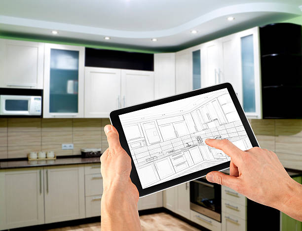 istock Hands holding tablet showing kitchen plans in finished room 153399816