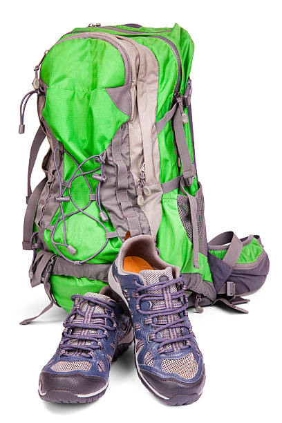 istock Pair of hiking shoes and backpack isolated on white background 153401184